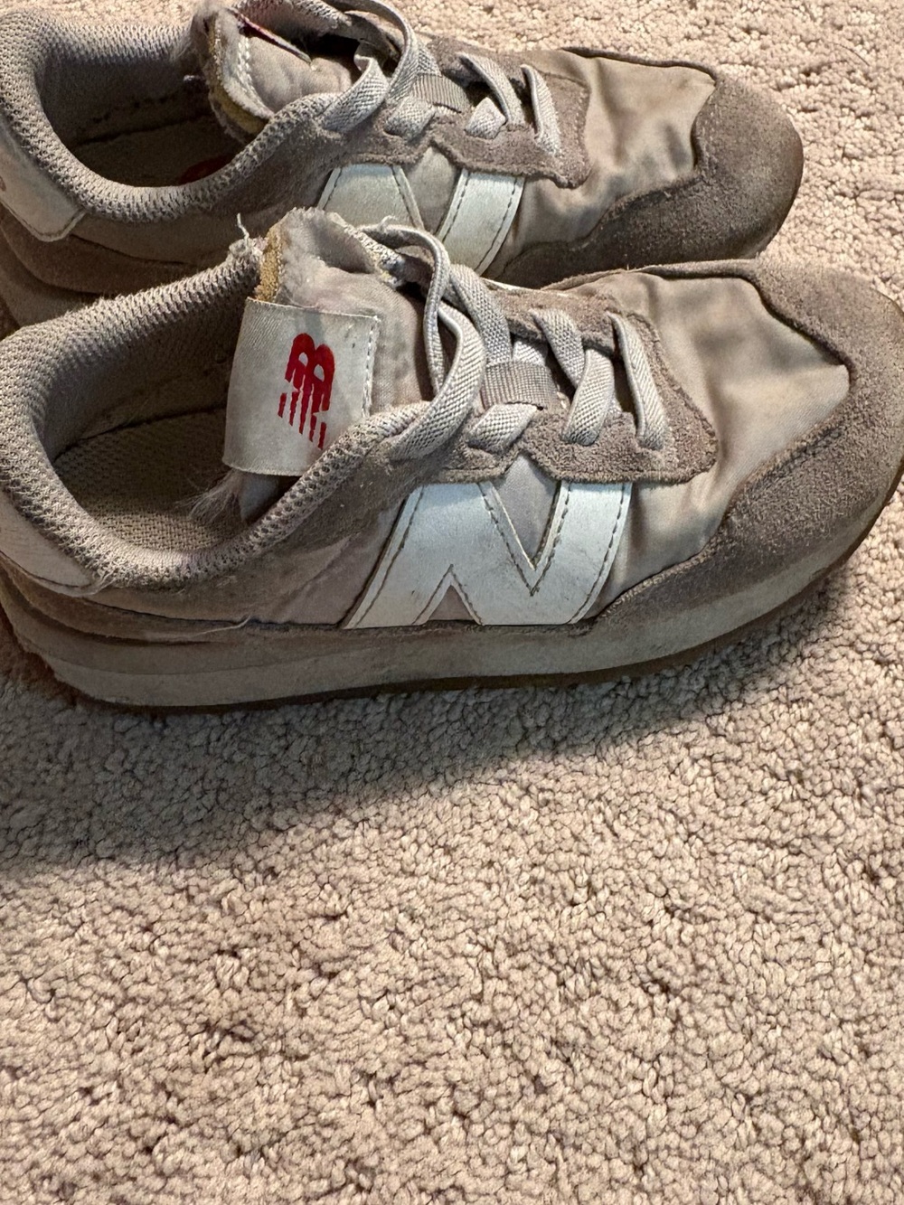 New Balance Kids Sneakers in Light Gray with White N Logo and Red Tongue Accent